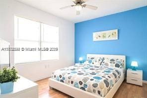 7326 Collins Ave Unit 102, Miami Beach, FL 33141 - bedroom with wood finished floors and ceiling fan