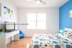 7326 Collins Ave Unit 102, Miami Beach, FL 33141 - bedroom featuring wood finished floors and a ceiling fan