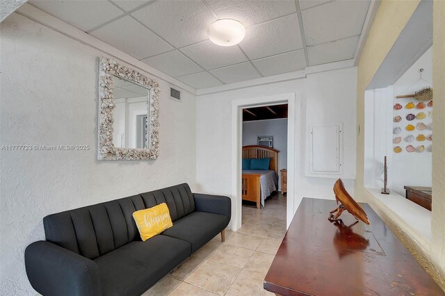 108 Long Ben Dr, Key Largo, FL 33037 - living room with tile patterned floors, a textured wall, and a drop ceiling