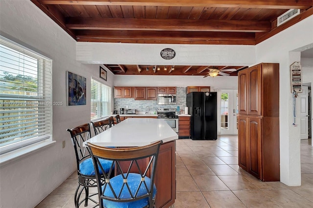 108 Long Ben Dr, Key Largo, FL 33037 - kitchen featuring tasteful backsplash, light countertops, wood ceiling, beamed ceiling, and stainless steel appliances