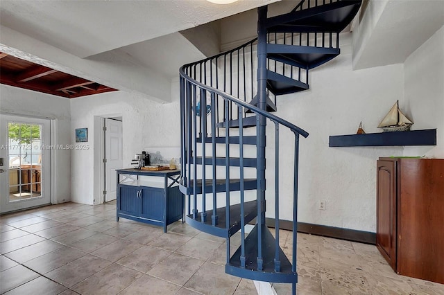 108 Long Ben Dr, Key Largo, FL 33037 - staircase with a textured wall, tile patterned flooring, baseboards, and beamed ceiling