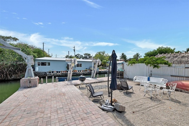 108 Long Ben Dr, Key Largo, FL 33037 - view of patio featuring a water view, a boat dock, fence, and boat lift