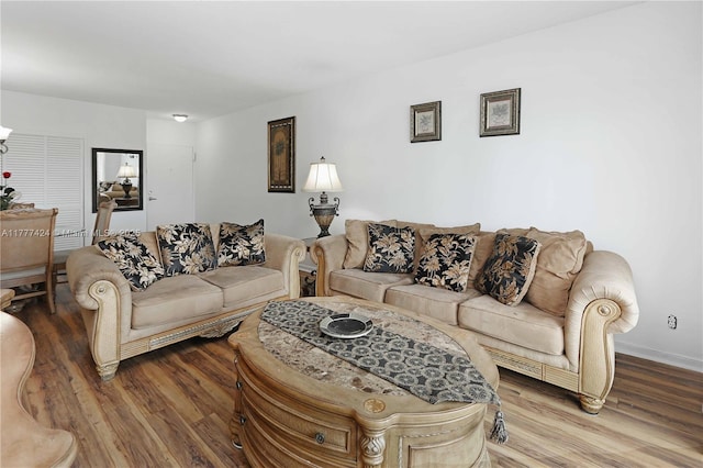 living area with wood finished floors and baseboards