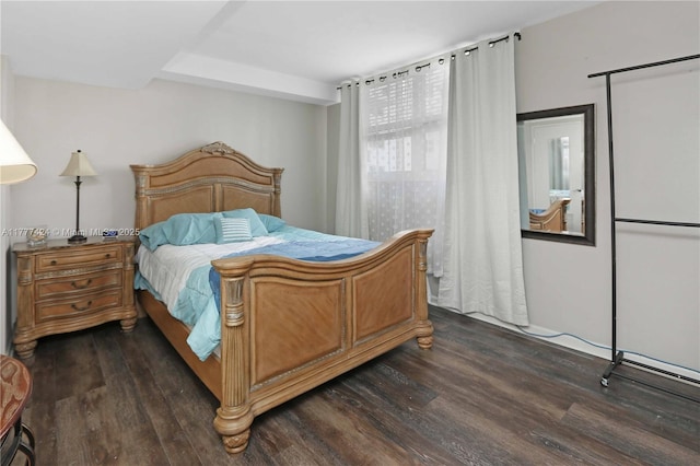 bedroom with dark wood finished floors