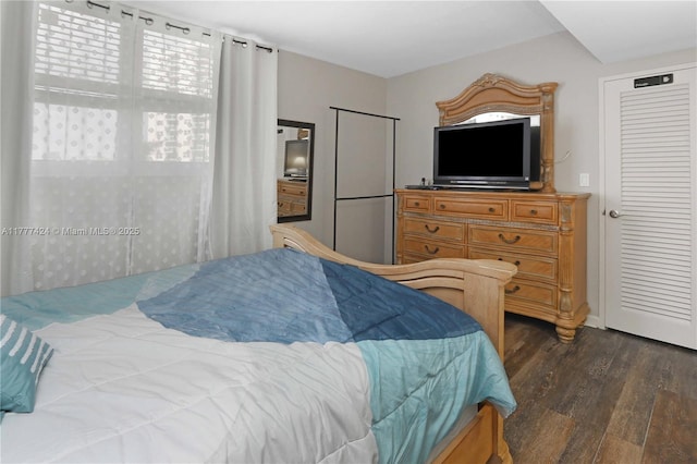 bedroom with dark wood-style flooring