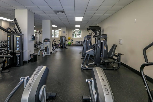 exercise room featuring visible vents, baseboards, and a drop ceiling