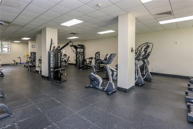 gym featuring visible vents, baseboards, and a paneled ceiling