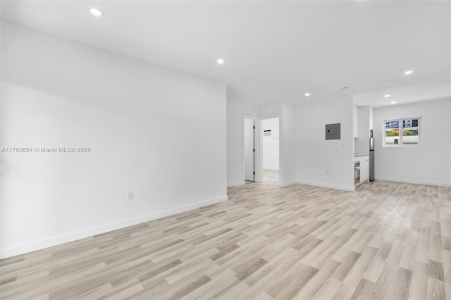 unfurnished living room with light wood-style floors, baseboards, and recessed lighting
