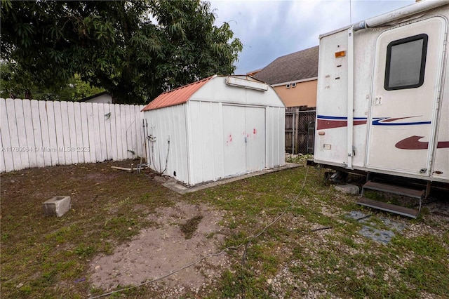 view of shed with entry steps and a fenced backyard