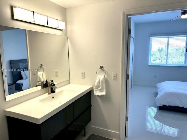 bathroom featuring baseboards, connected bathroom, and vanity