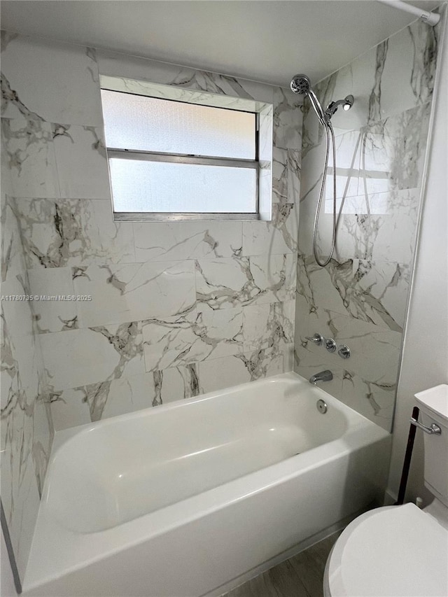 bathroom featuring toilet and shower / bathing tub combination