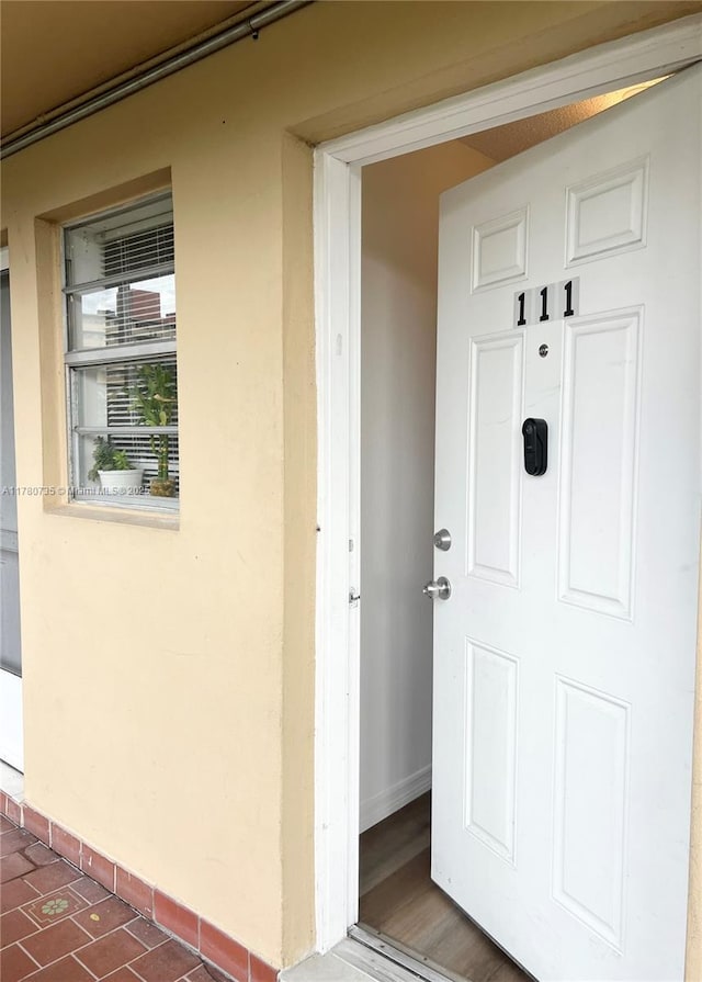 entrance to property with stucco siding