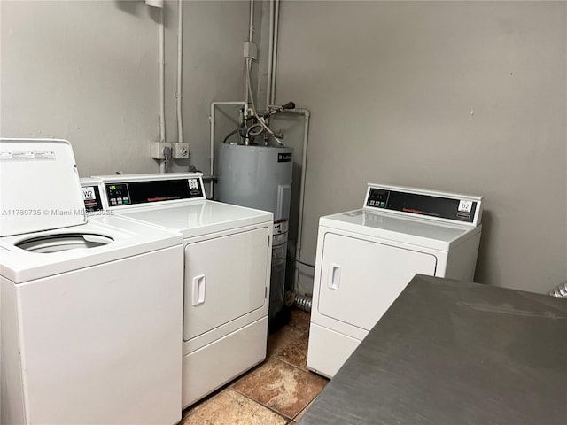 community laundry room with electric water heater and washer and clothes dryer