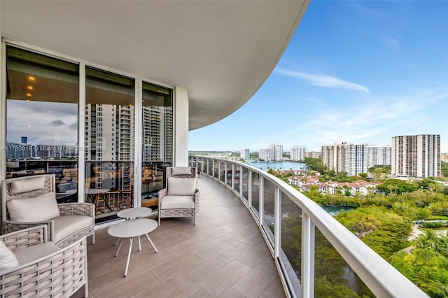 balcony featuring a water view and a view of city