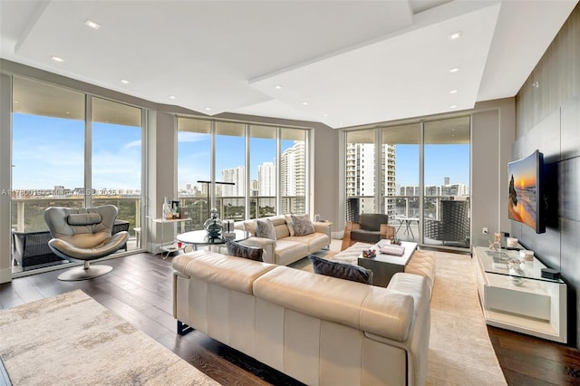 living room with hardwood / wood-style floors, floor to ceiling windows, and plenty of natural light