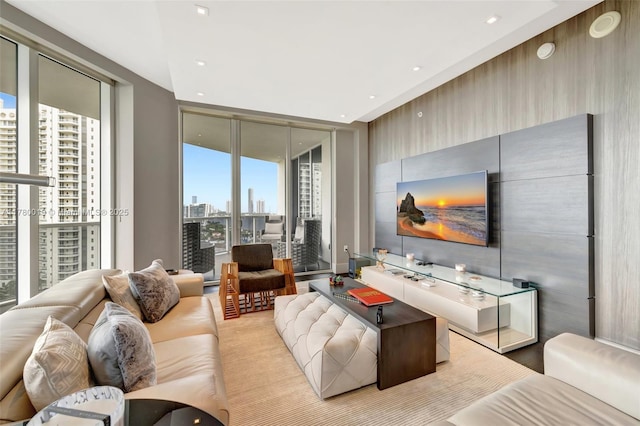 living area with a wealth of natural light, expansive windows, and recessed lighting