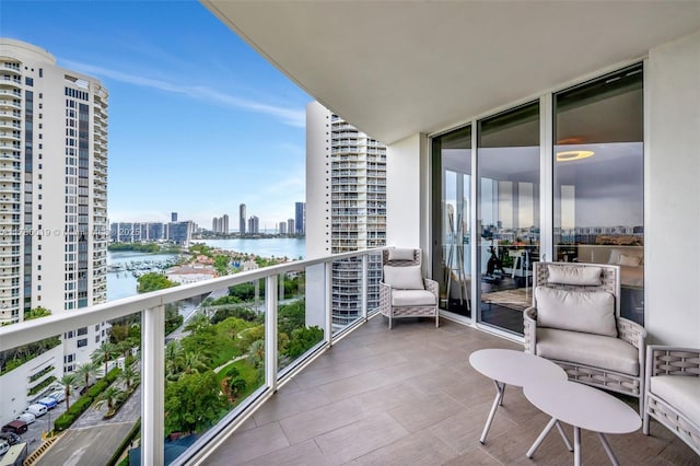 balcony featuring a water view and a view of city