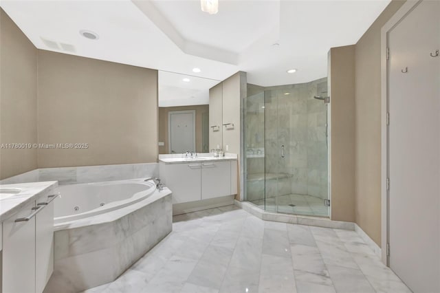 bathroom featuring a stall shower, vanity, a tub with jets, and recessed lighting
