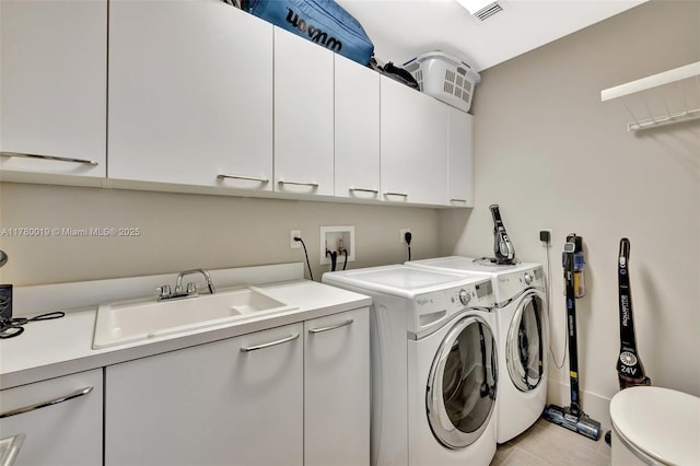 clothes washing area with visible vents, light tile patterned floors, a sink, cabinet space, and washer and clothes dryer