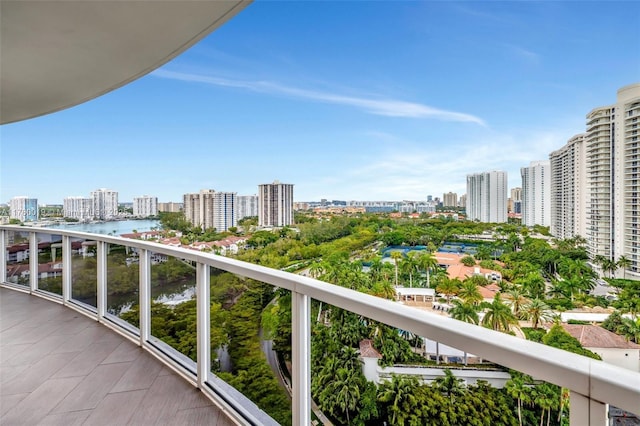 balcony featuring a view of city and a water view
