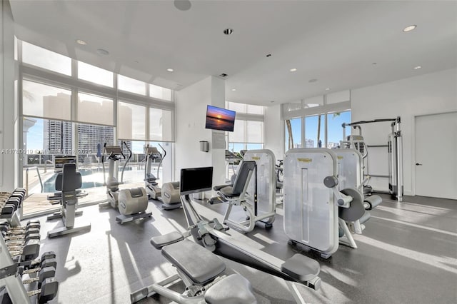 gym featuring floor to ceiling windows and recessed lighting