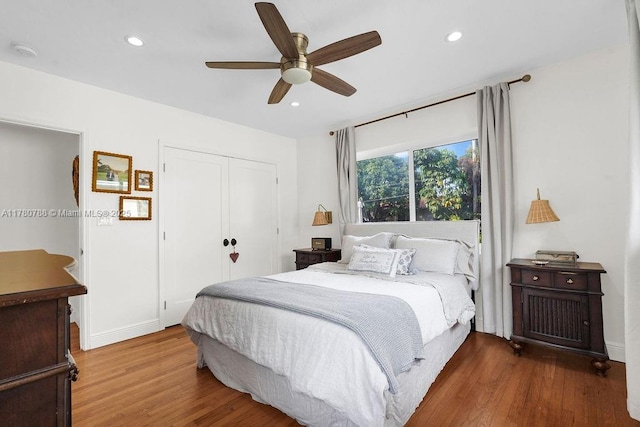 bedroom featuring a closet, recessed lighting, and wood finished floors