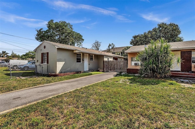ranch-style house with stucco siding and driveway