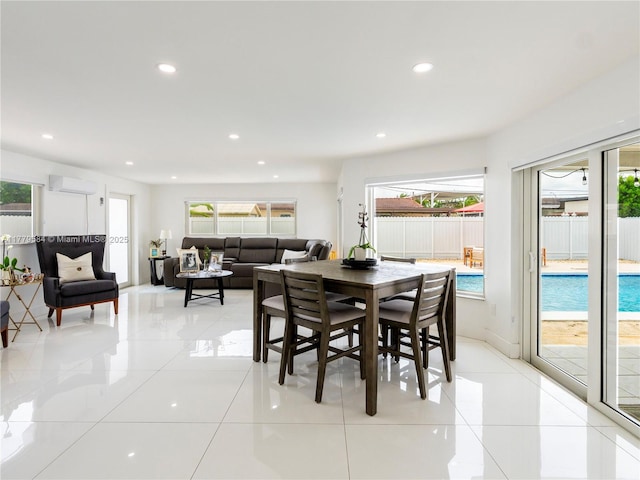 dining room with light tile patterned flooring, a healthy amount of sunlight, a wall mounted air conditioner, and recessed lighting
