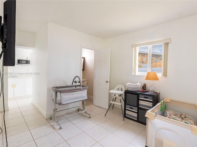interior space with light tile patterned floors and baseboards