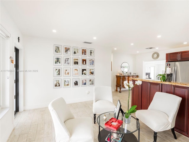 interior space featuring light wood finished floors, baseboards, visible vents, and recessed lighting