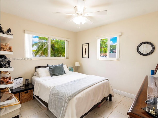 bedroom with light tile patterned floors, baseboards, and ceiling fan