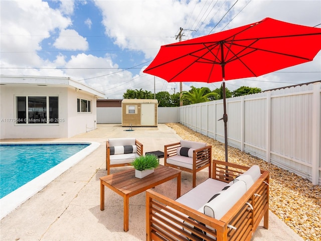 view of pool with a fenced backyard, an outdoor structure, a patio, an outdoor hangout area, and a fenced in pool