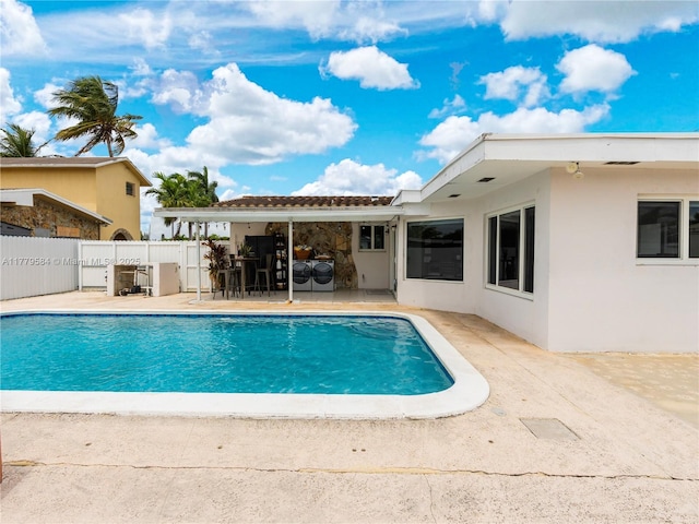 view of pool with a fenced in pool, a patio, and fence