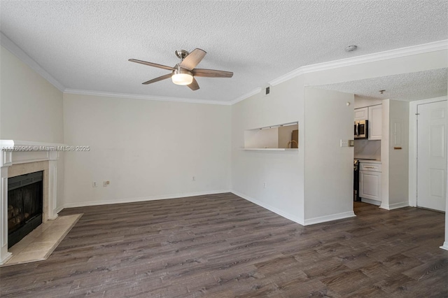 unfurnished living room featuring crown molding, a ceiling fan, a fireplace, and dark wood-style floors