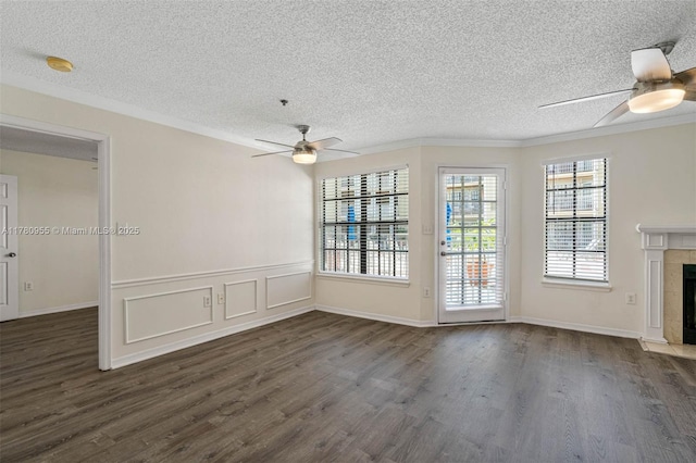 unfurnished living room featuring dark wood-type flooring, ceiling fan, and crown molding