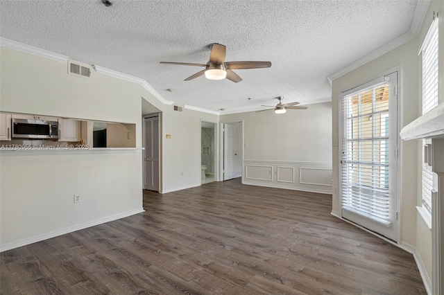 unfurnished living room featuring dark wood-style flooring, visible vents, a ceiling fan, and ornamental molding
