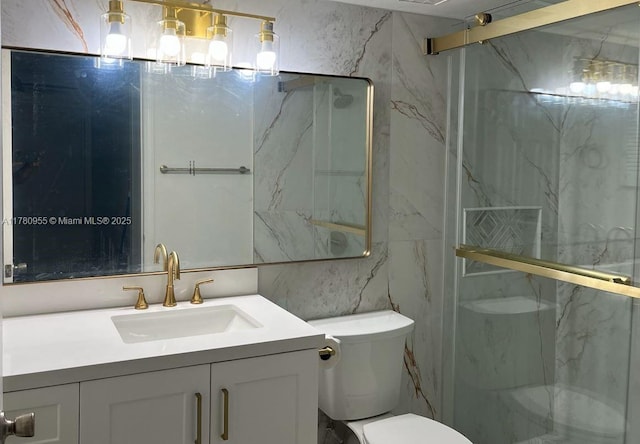full bathroom featuring a marble finish shower, tile walls, toilet, and vanity