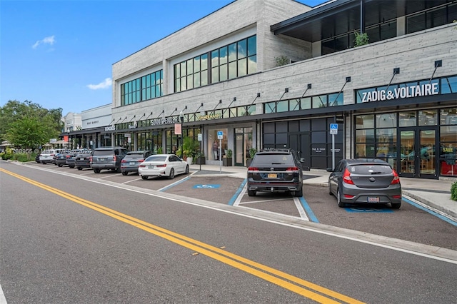 view of building exterior featuring uncovered parking