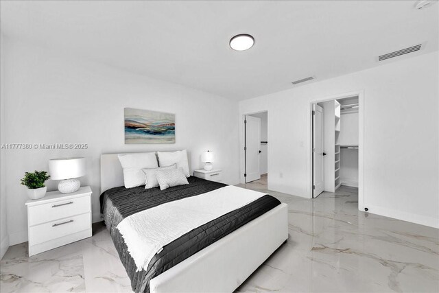 2021 SW 23rd St, Miami, FL 33145 - bedroom with light marble finish floors, baseboards, and a spacious closet