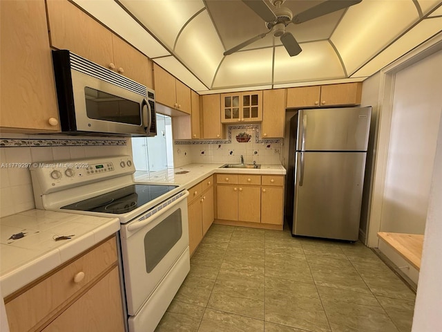 1825 S Ocean Dr Unit 503, Hallandale Beach, FL 33009 - kitchen featuring appliances with stainless steel finishes, tile counters, tasteful backsplash, a ceiling fan, and light brown cabinetry