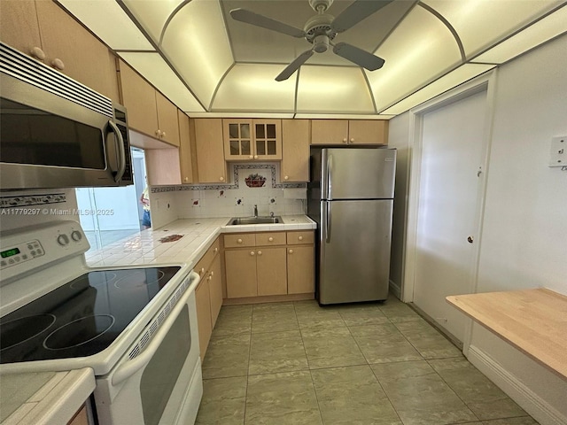 1825 S Ocean Dr Unit 503, Hallandale Beach, FL 33009 - kitchen with appliances with stainless steel finishes, tile countertops, a ceiling fan, tasteful backsplash, and light tile patterned floors