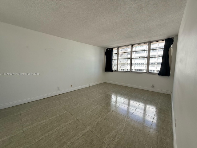 1825 S Ocean Dr Unit 503, Hallandale Beach, FL 33009 - spare room with a textured ceiling and tile patterned floors