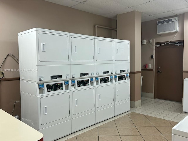 1825 S Ocean Dr Unit 503, Hallandale Beach, FL 33009 - community laundry room with stacked washer / dryer, light tile patterned floors, washing machine and clothes dryer, and an AC wall unit