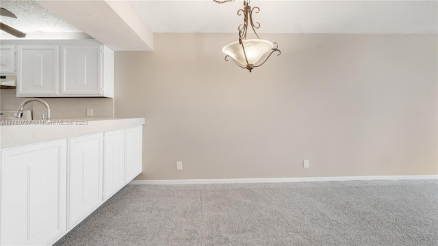 6106 Coral Lake Dr Unit 106, Margate, FL 33063 - unfurnished dining area featuring baseboards, a sink, ceiling fan, a textured ceiling, and carpet floors
