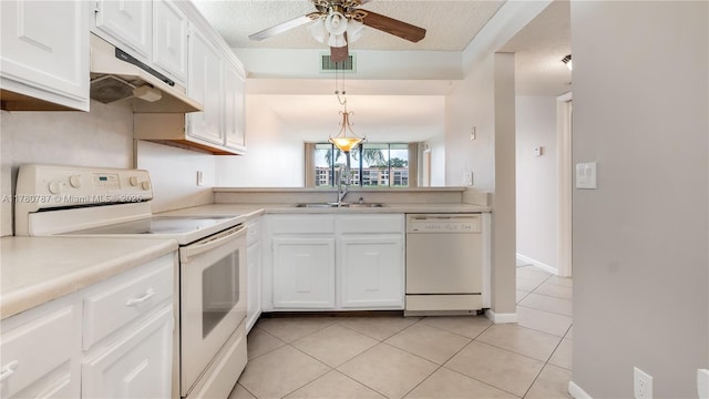 6106 Coral Lake Dr Unit 106, Margate, FL 33063 - kitchen featuring white appliances, light tile patterned floors, white cabinetry, under cabinet range hood, and visible vents