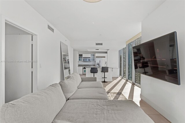living room with visible vents and light tile patterned floors