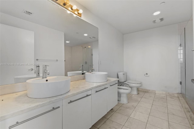 bathroom featuring a bidet, a sink, visible vents, and a stall shower