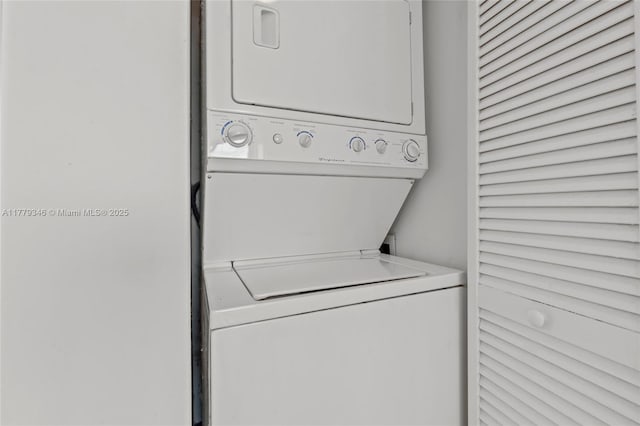 laundry room with stacked washer / dryer and laundry area
