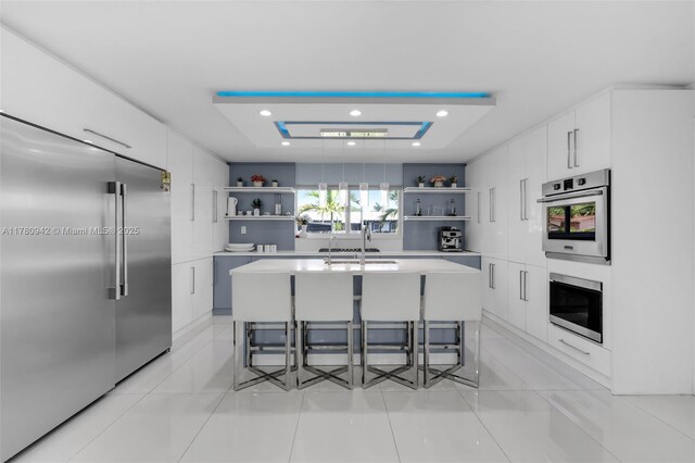 4140 N 36th Ave, Hollywood, FL 33021 - kitchen featuring white cabinetry, open shelves, modern cabinets, and stainless steel appliances