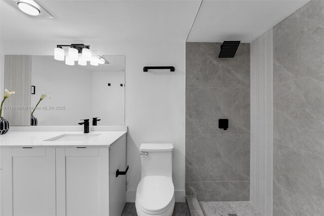 1301 NE 191st St Unit F117, Miami, FL 33179 - bathroom featuring toilet, tiled shower, and vanity